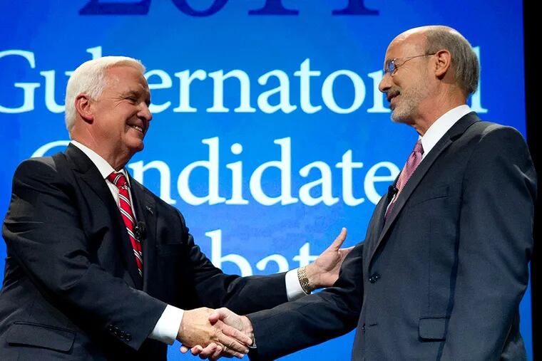 Republican Gov. Tom Corbett, left, and Democrat Tom Wolf shake hands at the end of a gubernatorial debate hosted by the Pennsylvania Chamber of Business and Industry, Monday, Sept. 22, 2014, in Hershey, Pa. (AP Photo/Matt Rourke)