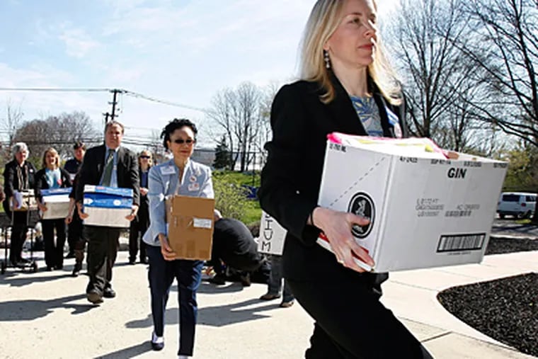 Clean water advocate Erika Staaf led a line of people Thursday to deliver boxes of public comments to federal regulators at the Delaware River Basin Commission in West Trenton. (Mel Evans / Associated Press)