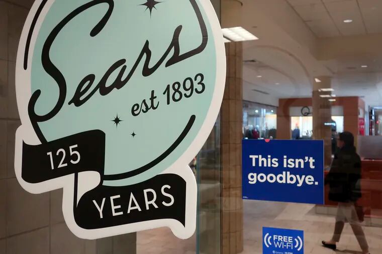 In this Nov. 2, 2018 photo, a sign in the window at Sears promises that "This isn't goodbye," at the Livingston Mall in Livingston, N.J. Sears is closing 80 more stores as it teeters on the brink of liquidation. The 130-year old retailer set a deadline of Friday, Dec. 28, 2018, for bids for its remaining stores to avert closing down completely.