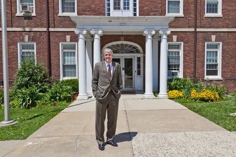 Dr. Christopher Hall, Dean of the Palmer Theological Seminary, stands outside the iconic seminary hall that will become apartments once they move to St. Davids in August. (ELISE WRABETZ / Staff Photographer)