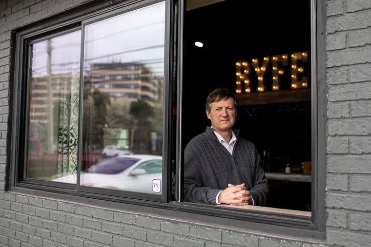John Murphy, owner of Ryfe, at the window of his bar and restaurant along Atlantic Avenue in Atlantic City.