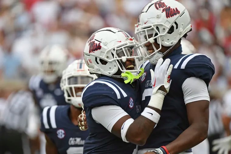Mississippi safety Isheem Young (left) and safety Otis Reese celebrate during the victory against Troy in Oxford, Miss. The former Imhotep star recovered a fumble for the Rebels.
