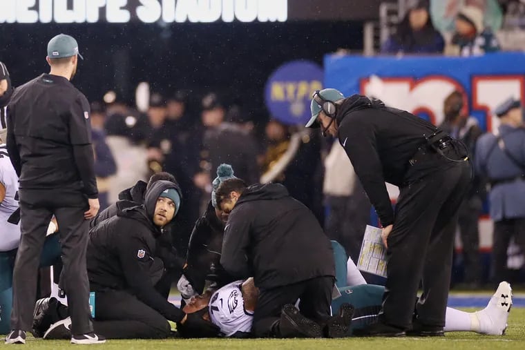 Medical staff checking on Eagles guard Brandon Brooks (79) after he was injured in the second quarter of Sunday's game.