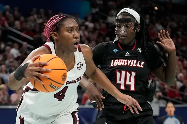 South Carolina's Aliyah Boston (left) drives past Louisville's Olivia Cochran during the first half.