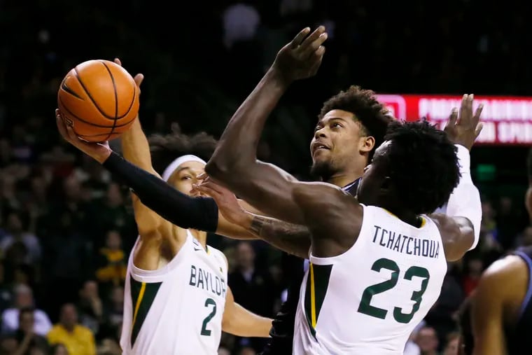Villanova guard Justin Moore, left, drives past Baylor forward Jonathan Tchamwa Tchatchoua (23) to the basket during the first half of an NCAA college basketball game on Sunday, Dec. 12, 2021, in Waco, Texas. (AP Photo/Ray Carlin)