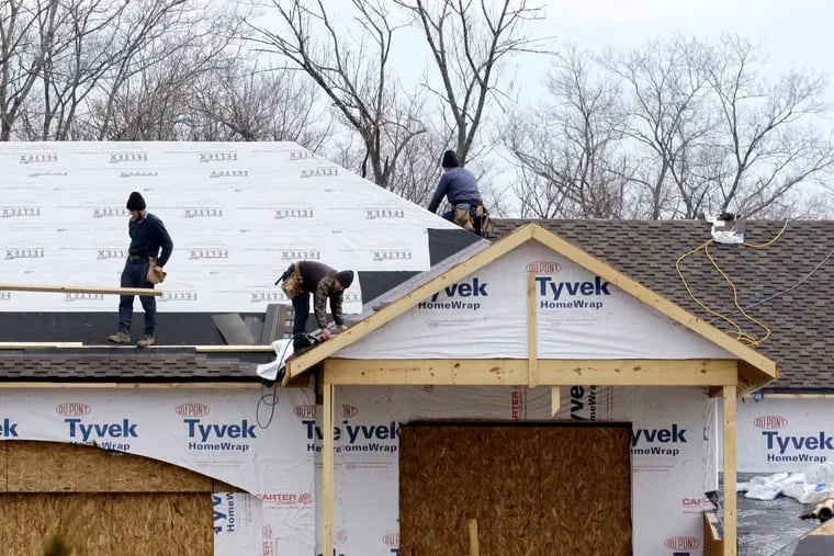 In this March 21, 2014 photo, roofers install a roof on a new construction home in Pepper Pike, Ohio. Delaware Valley Consumers' Checkbook gives tips on how to find a high quality roofer at reasonable prices.