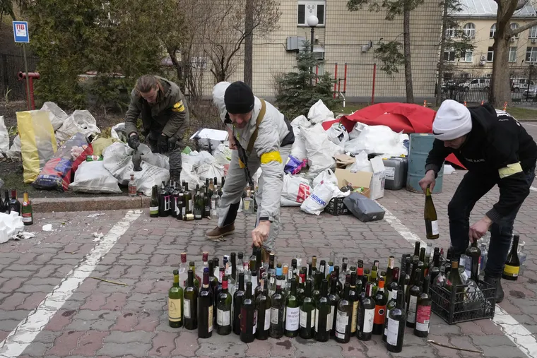 Civil defense members preparing Molotov cocktails in a yard in Kyiv, Ukraine, oon Feb. 27, 2022. On social media, the world has cheered Ukrainians as they stockpile Molotov cocktails and take up arms against an occupying army.