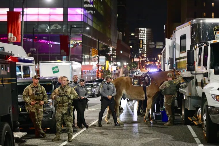 State police officers arrive at the Municipal Services Building in Center City Philadelphia as curfew began on Wednesday, Oct. 28, 2020.