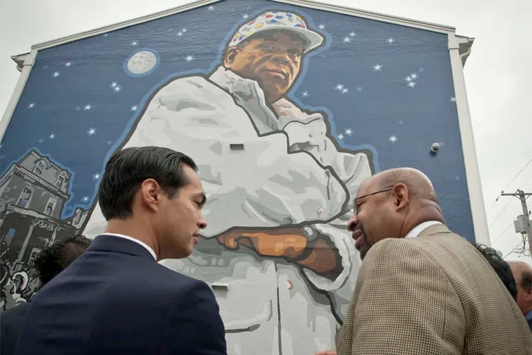 Mayor Nutter explains the Mural Arts Program to HUD chief Juli&#0225;n Castro in front of the Herman Wrice mural.