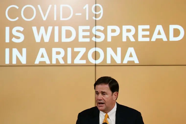 Arizona Gov. Doug Ducey speak\ings about the latest coronavirus data at a news conference Thursday in Phoenix.