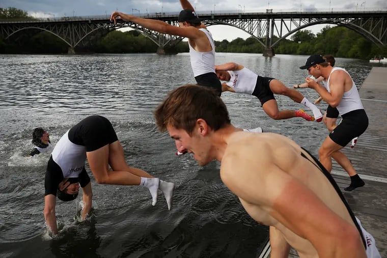 Temple men's varsity heavyweight eight crew members jump into the water to celebrate their win during the 82nd Annual Jefferson Dad Vail Regatta along the Schuylkill River in Philadelphia on Saturday, May 8, 2021.