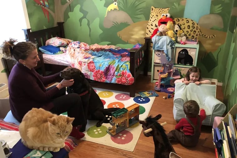 Nicole Simon, 46, is a mother of two working from home on a snow day and caring for Ariana, 3, and Lucas, 20 months. Linus, the chocolate lab, and Peanut, the cat, are around, too.