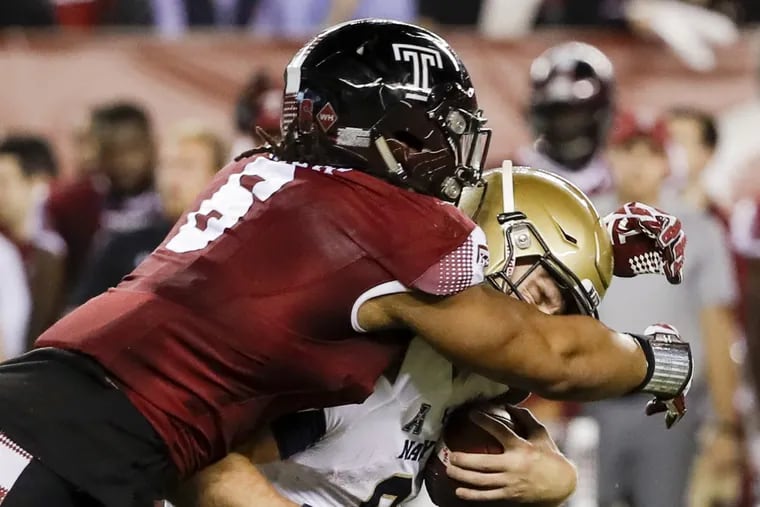 Temple defensive lineman Sharif Finch stops Navy quarterback Zach Abey on Thursday.