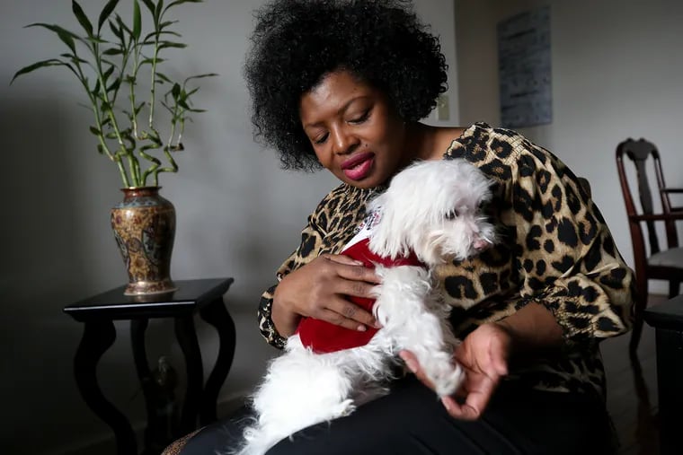 Jenee Davis plays with her dog, Prince, at her home in Hasbrouck Heights, N.J., on March 8, 2020. Davis needed surgery and then inpatient rehab that would keep her away from home and her dog for four months. She had no one to care for the dog, so she called PACT for Animals, an animal-fostering nonprofit that offers free foster care to medical patients or deploying military members in need.