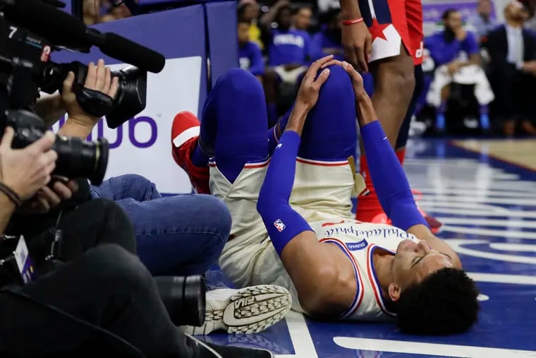 Sixers guard Matisse Thybulle lies on the floor after falling down during the fourth-quarter against the Washington Wizards on Saturday, December 21, 2019 in Philadelphia.