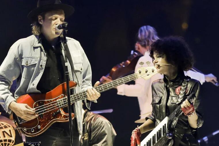 Arcade Fire&#039;s Win Butler and Regine Chassagne perform at the Wells Fargo Center on Sunday.