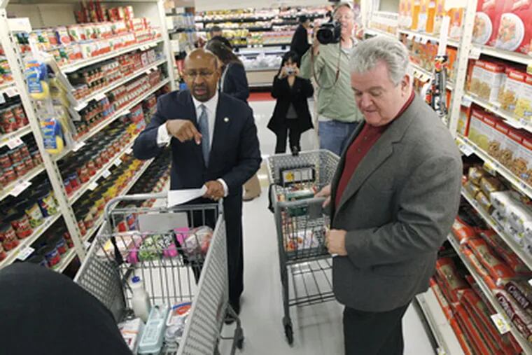 Mayor Michael Nutter, left, and Rep. Robert Brady, D-Pa., meet as they shop at a ShopRite grocery story Monday, April 23, 2012, in Philadelphia. Nutter and Brady pledged Monday to live on the average food stamp benefit of five dollars a day for the entire week.  (AP
Photo/Matt Rourke)