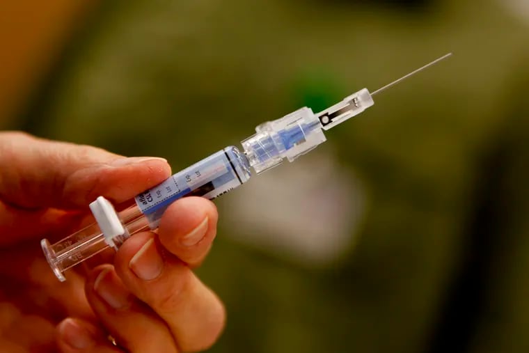 Downey Regional Medical Center RN Connie Meinke holds a syringe filled with the flu vaccine before injecting a fellow employee on January 17, 2013. Like many hospitals across the U.S., the Downey, California, facility is preparing for the flu onslaught. The hospital is asking all of their employees to be vaccinated.
