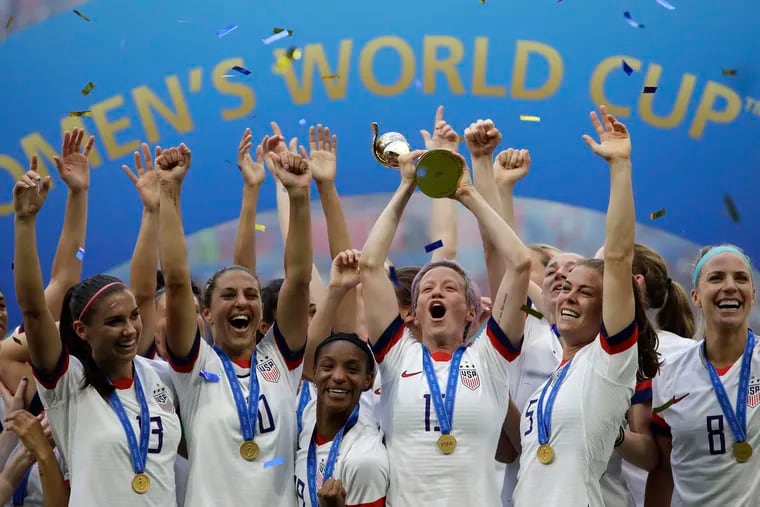 Megan Rapinoe lifts up the trophy after winning the Women's World Cup final soccer match between the U.S. and the Netherlands at the Stade de Lyon in Decines, outside Lyon, France, in July 7, 2019. The U.S. Soccer Federation reached milestone agreements to pay its men's and women's teams equally, making the American national governing body the first in the sport to promise both sexes matching money.