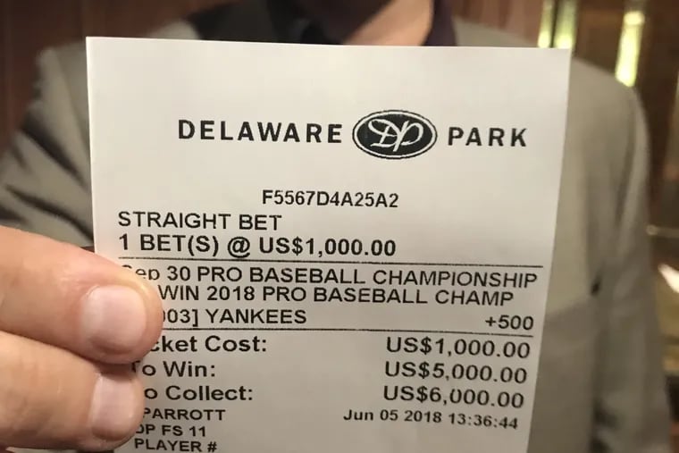 Professional sports gambler Tom Barton shows off the $1,000 wager he placed last June at Delaware Park on the Yankees to win the 2018 World Series. New York lost in the divisional series.