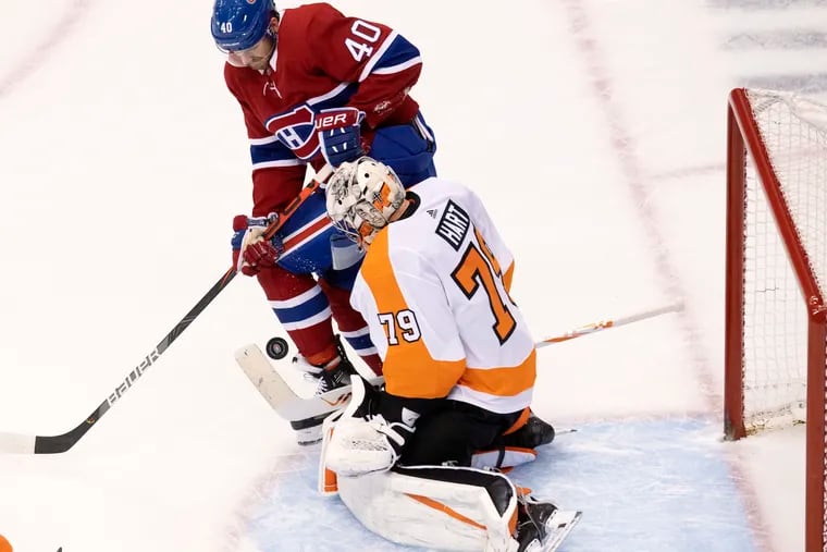 Philadelphia Flyers goaltender Carter Hart (79) makes a save under pressure from Montreal Canadiens right wing Joel Armia (40).