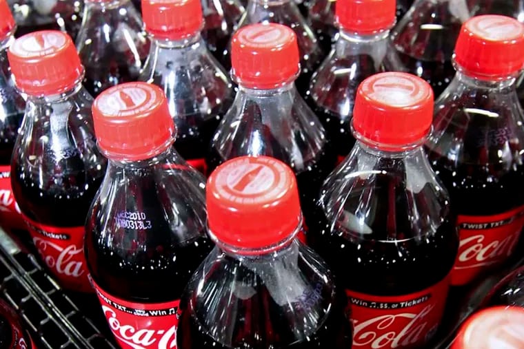 Bottles of Coca-Cola soda wait to be loaded.