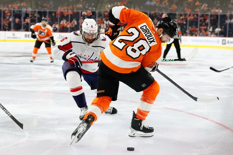 Flyers left winger Claude Giroux looks back for the puck against Washington Capitals defenseman Michal Kempny in a preseason game Saturday. Giroux had a goal in the Flyers' 3-1 win.