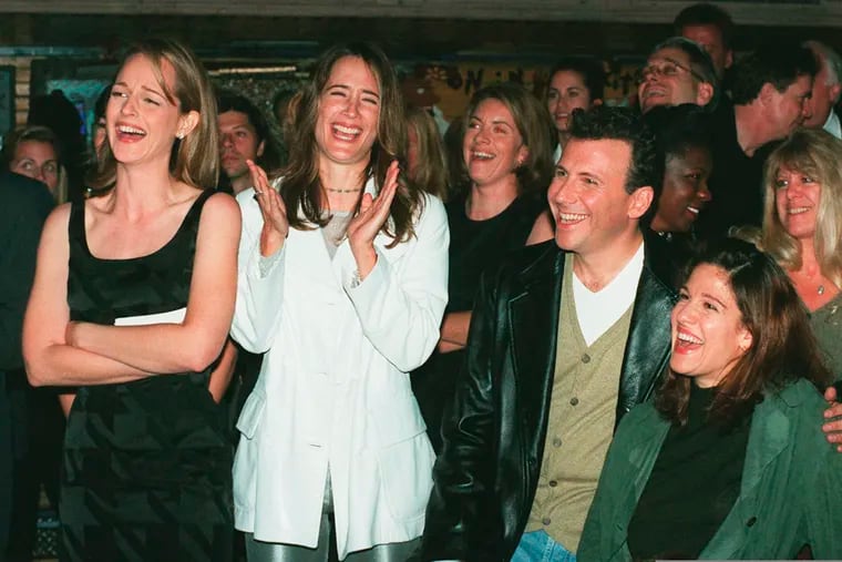 In this Nov. 11, 1996, file photo, "Mad About You" cast members (from left) Helen Hunt, Anne Ramsay, and Paul Reiser and Reiser's wife, Paula, laugh at a satiric video made by the show's crew during a private party at the House of Blues in West Hollywood, Calif., to celebrate the NBC television comedy's first 100 episodes.