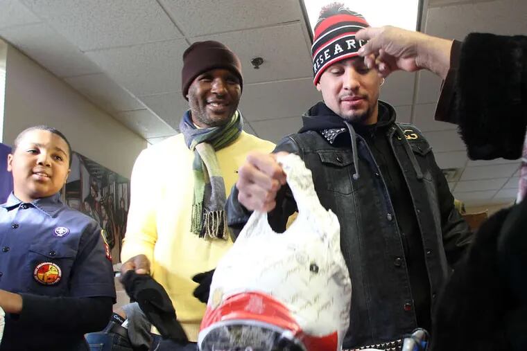 A fistful of turkey: Boxing champions Bernard Hopkins (center) and Danny Garcia at Red Cross House.