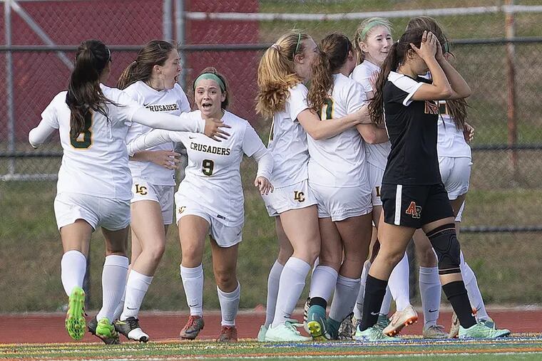 Lansdale Catholic celebrates after scoring in overtime to beat Archbishop Ryan and with the Catholic League title at Northeast High School stadium on Sunday.