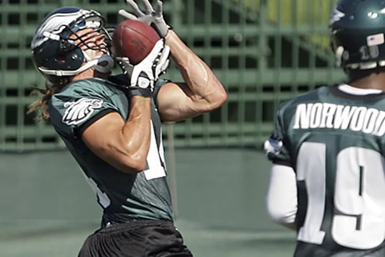 Rookie wide receiver Riley Cooper mixed it up with cornerback Ellis Hobbs on Saturday. (Yong Kim / Staff Photographer)