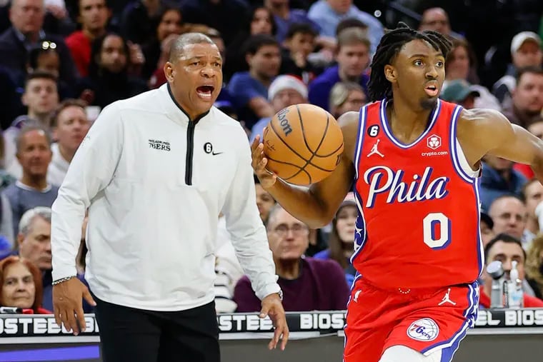 Sixers guard Tyrese Maxey dribbles the basketball with Head Coach Doc Rivers yelling instructions against the Chicago Bulls on Friday, January 6, 2023 in Philadelphia.
