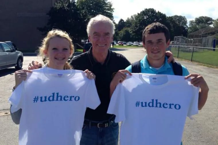 Upper Darby Police Superintendent Michael Chitwood poses with high-school students who were among the first 50 to receive the popular new shirts. Residents can receive the shirt by committing a good deed or kind act and tweeting about it to @UDPolice.