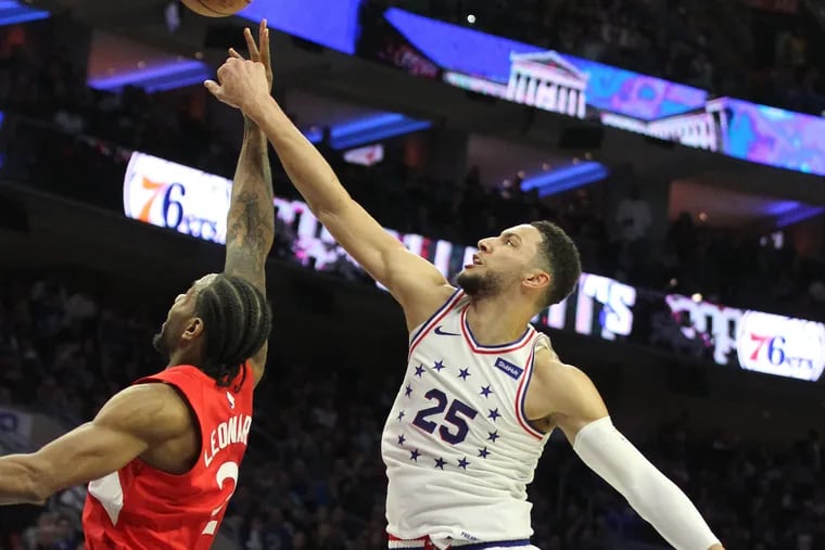 Ben Simmons, right, Toronto Raptors standout Kawhi Leonard go after a rebound in Sunday's Game 4  of their teams' playoff series.