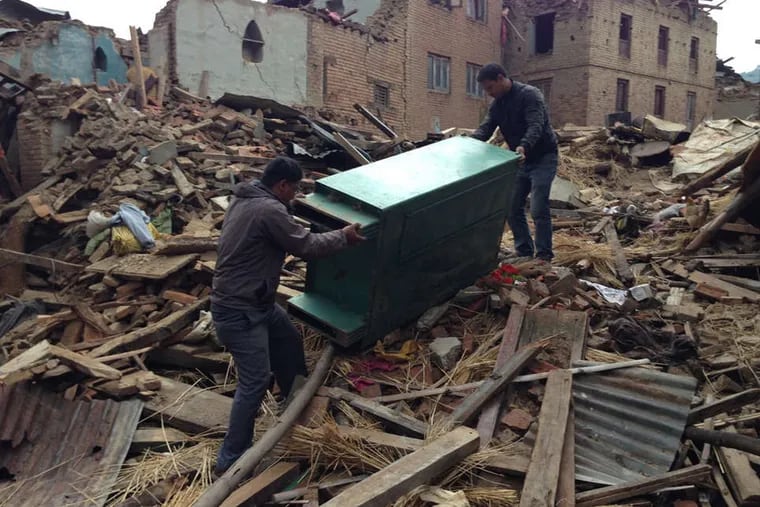Salvaging furniture from the quake's wreckage in Nepal. In villages that were destroyed, most homes were made of unfired brick and clay mortar.