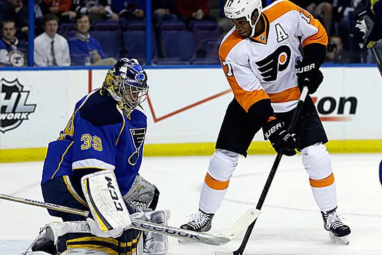 The Flyers' Wayne Simmonds watches as Blues goalie Ryan Miller deflects a puck during the first period. (Jeff Roberson/AP)