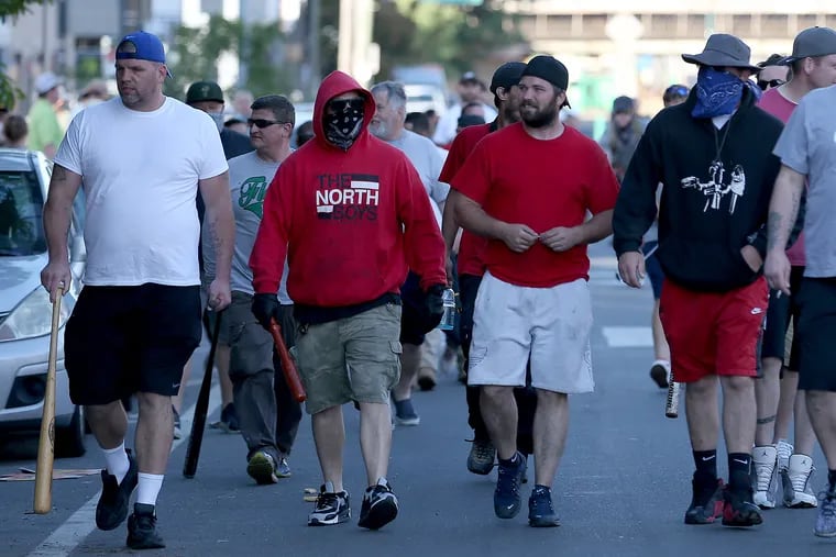 A group, who called themselves old-time Fishtowners, walk west on Girard Avenue carrying bats, hammers and shovels. The men said they believed they were protecting their neighborhood in the event looters or rioters showed up in Fishtown.