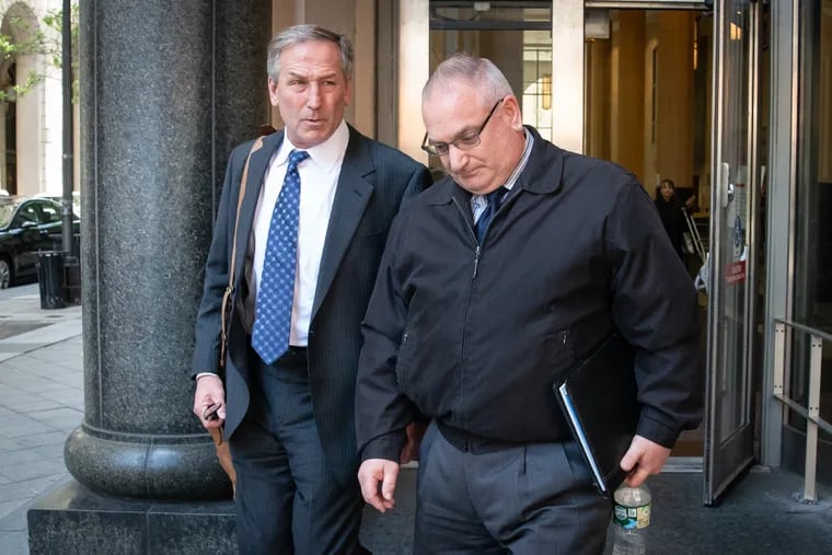 Former Philadelphia homicide detective Philip Nordo leaves the Criminal Justice Center in Philadelphia with his lawyer, Michael van der Veen, on May 10.