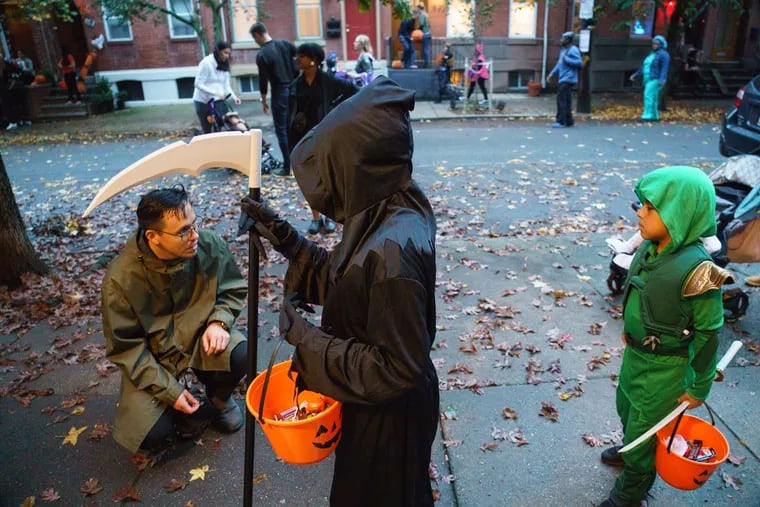 Trick or Treaters making their Halloween candy rounds on South 13th Street, between Morris and Reed Streets, in Philadelphia in 2019. The block was closed to motor vehicles for trick-or-treating and a block party.