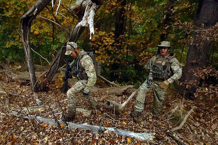 ATF agents search a section of woods in Price Township, near Canadensis, Pa., Wednesday, Oct. 1, 2014, as the search for suspected killer Eric Frein continues. Tourism officials in the Pocono Mountains say that while visitors are calling to ask about the manhunt for Frein — now in its third week — very few of them are canceling their hotel and outing reservations during one of the busiest times of the year. (AP Photo/Scranton Times-Tribune, Butch Comegys) WILKES BARRE TIMES-LEADER OUT; MANDATORY CREDIT