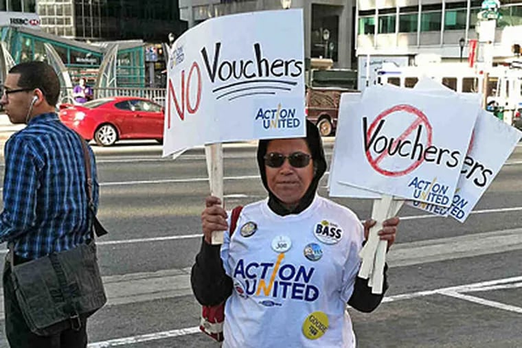 Anti-voucher parent Alicia Dorsey, of Mount Airy, protested at conference where Gov. Corbett spoke. (Peter Mucha / Inquirer Staff)