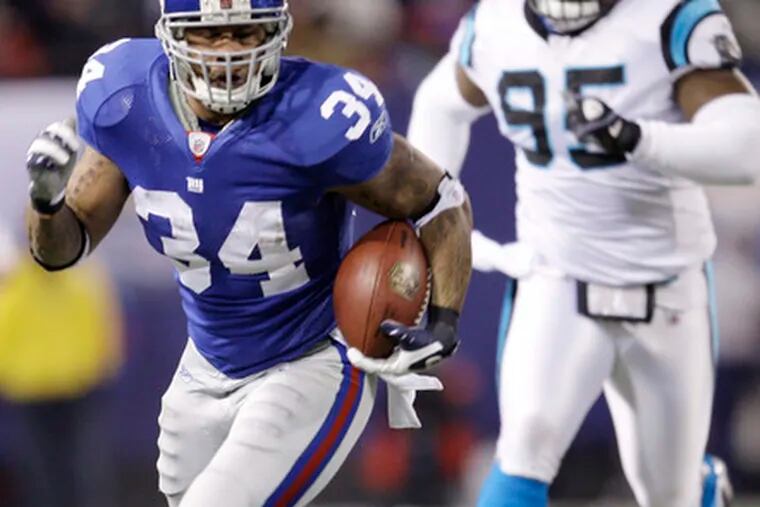 New York Giants&#0039; Derrick Ward runs for a 34-yard gain with Carolina&#0039;s Charles Johnson in pursuit. Ward carried 15 times for 215 yards.