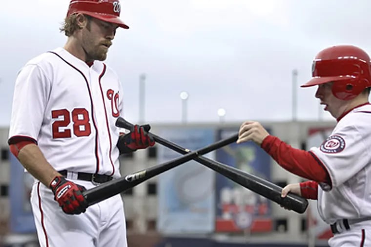 Jayson Werth exchanges his bat after breaking it during the first inning of the Nationals' 7-4 win over the Phillies. (AP Photo/Manuel Balce Ceneta)