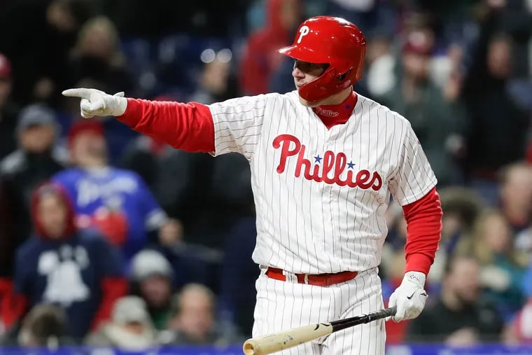 Rhys Hoskins pointing into the Phillies dugout after drawing an RBI walk during the fifth-inning against the Braves on Sunday.