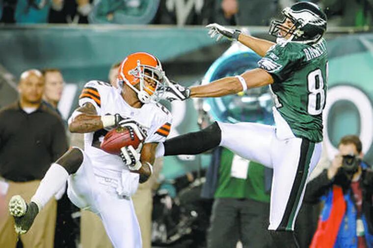 The Browns&#0039; Brandon McDonald (left) intercepts a pass for Hank Baskett in the end zone on the final play of the first half.