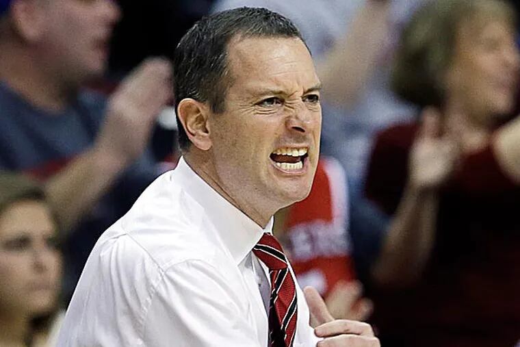 Rutgers said it would reconsider its decision to retain men's basketball coach Mike Rice after a videotape was televised showing him abusing players. (Mel Evans/AP)
