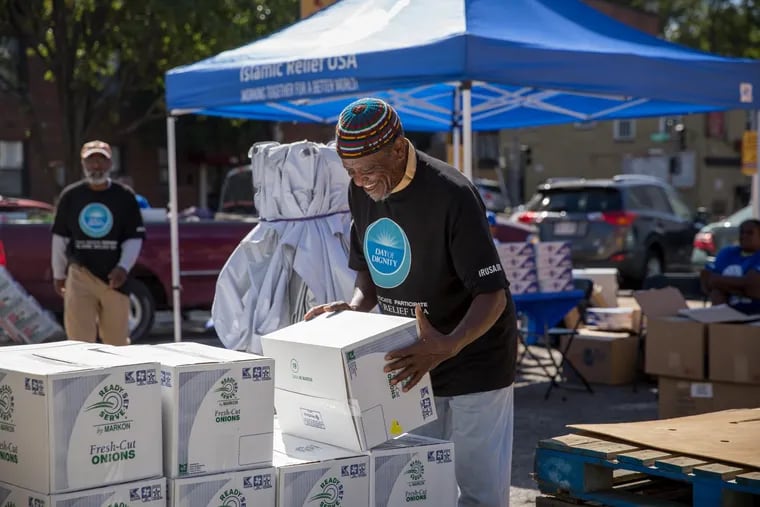 An Islamic Relief USA volunteer arranges boxes of non perishable foods at a Day of Dignity event in Washington, D.C. on Oct. 5. Day of Dignity will take place at two locations in Philadelphia on Oct. 26. The events provide essential items like hot meals, winter coats and hygiene products, as well as services like medical screenings, to individuals living in poverty.