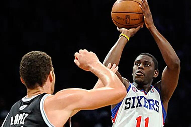 Jrue Holiday scored 11 points in the Sixers' 106-96 win over the Nets on Friday. (Kathy Kmonicek/AP)