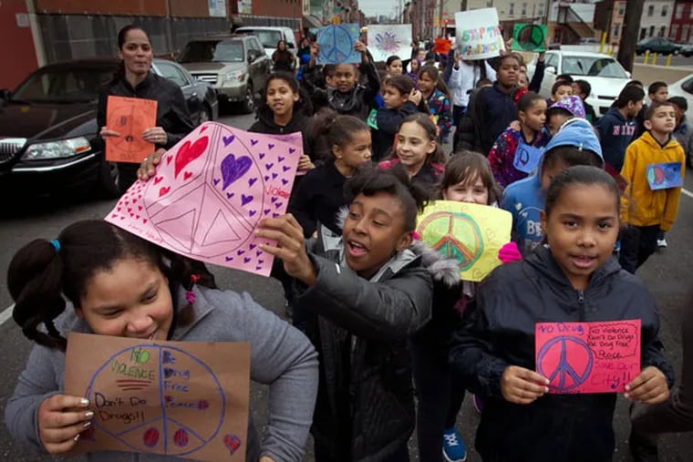 Students from Julia de Burgos Elementary School march through the streets November 25, 2014, demanding a stop to violence in their community. ( ALEJANDRO A. ALVAREZ / STAFF PHOTOGRAPHER )