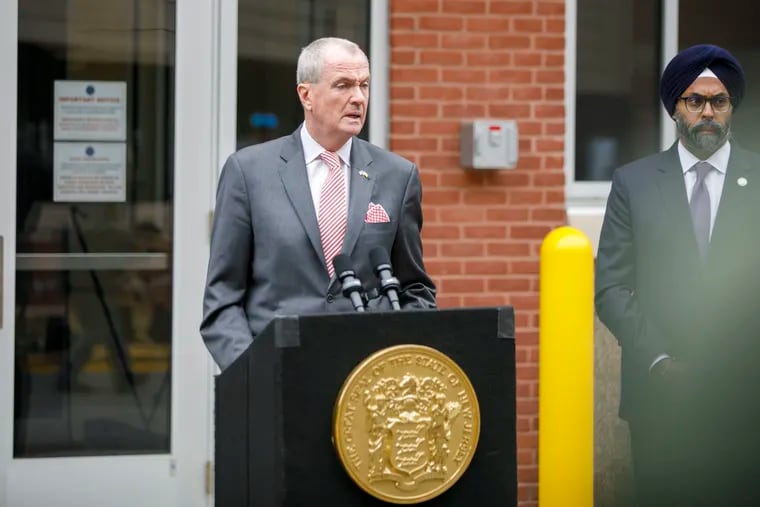 New Jersey Gov. Phil Murphy speaks on Monday during a news conference at the Cumberland County Prosecutor's Office in Bridgeton, N.J., following Saturday's mass shooting in Fairfield Township where two people were killed and 12 others wounded. Attorney General Gurbir S. Grewal stands next to him.